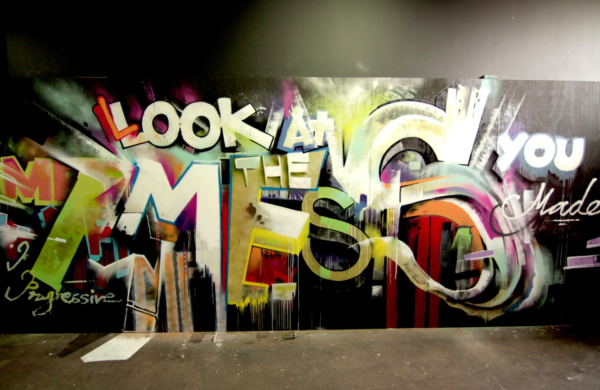 Interior graffiti wall with 'Look at me' lettering in bright colours
